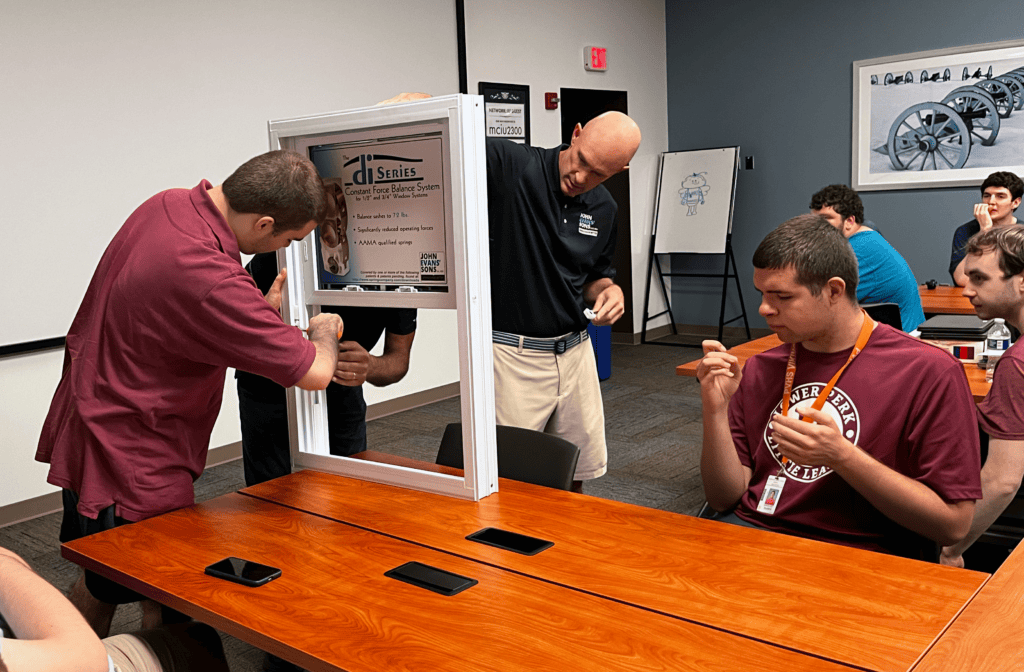 MCIU student with Same Davey looking at constant force spring window balance system.