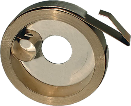 One tightly coiled power spring on a flat surface, displaying its compact and durable design.
