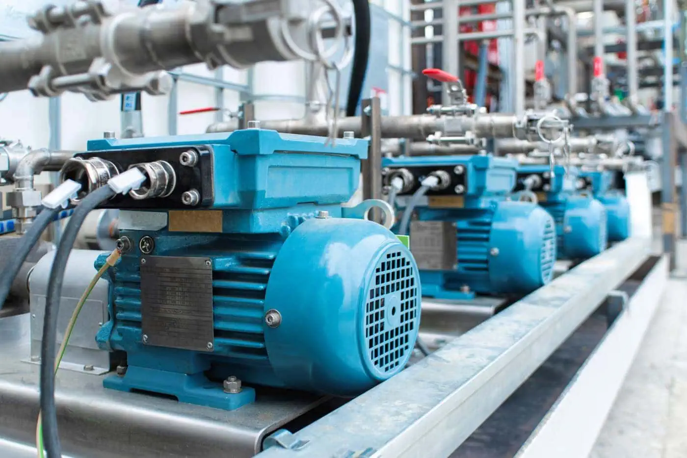 A row of electric motors in a factory setting, where motor brush springs ensure consistent electrical contact for optimal performance. Powering efficiency—motor brush springs play a crucial role in maintaining reliable electrical contact in electric motors, ensuring smooth and efficient operation.